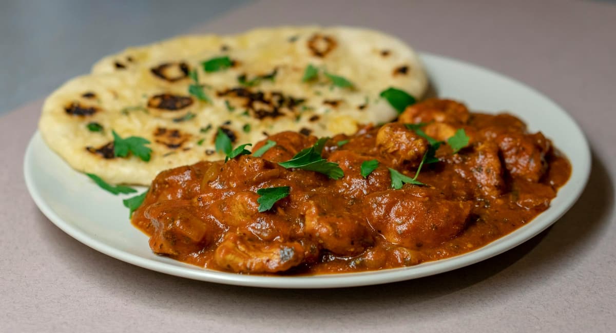 Meat masala with fresh coriander served alongside charred naan
